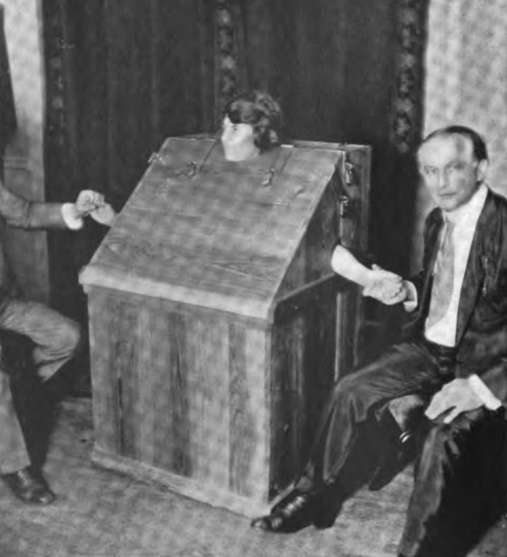 The famous medium, Mina Crandon, being tested by Harry Houdini for eventual fraud in her spirit seances 1923