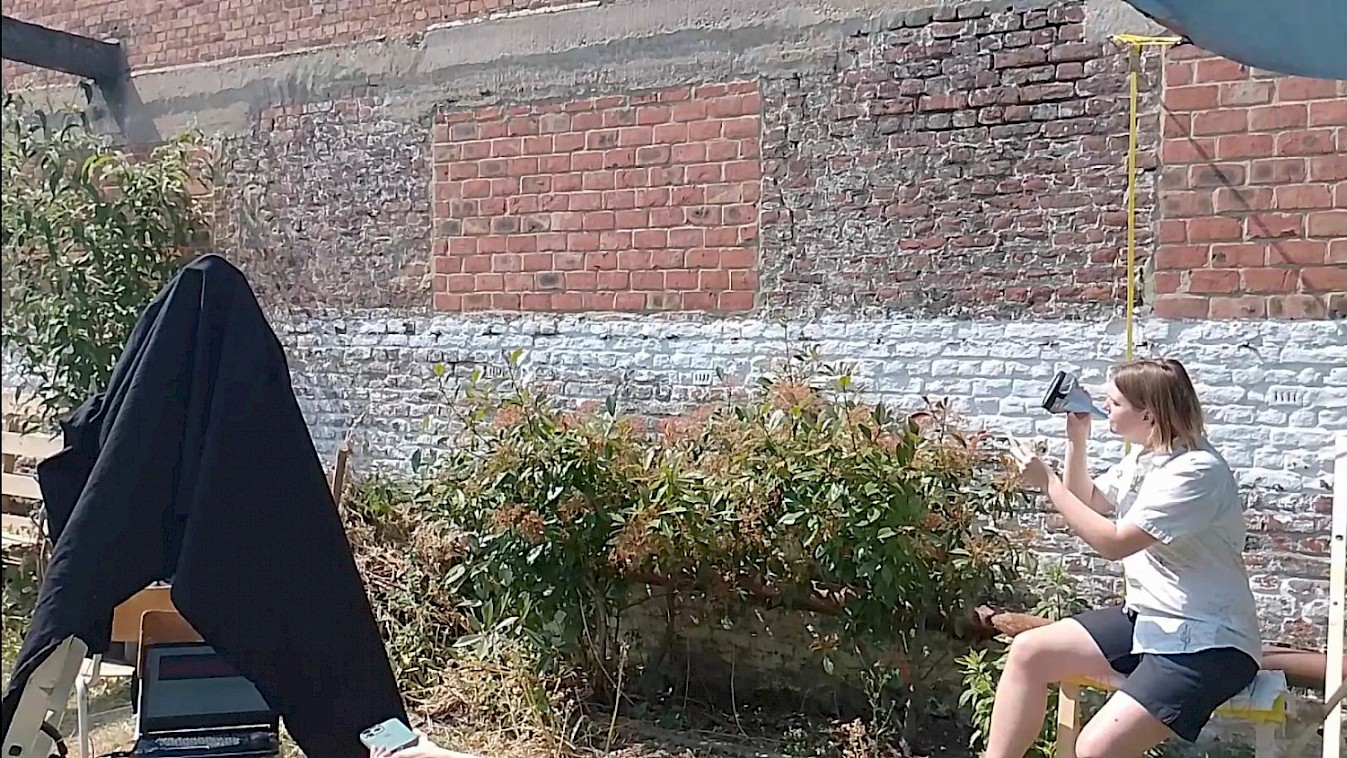 Mia reading a poem, directly modulating the voice through the sun ray that is directed on the solar pannel